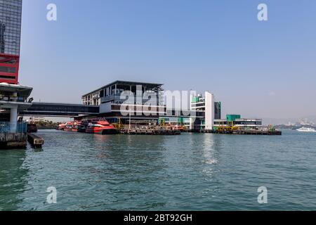 Sheung Wan, Hong Kong  - February 22, 2020 : Hong Kong - Macau Ferry Terminal at Victoria Habour. High-speed crafts are berthed at pier. All the saili Stock Photo