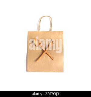 Eco fork and spoon food made from natural eco recycle reusable material laying on the carton craft shopping bag isolated on white background. Eco Zero Stock Photo
