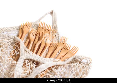 Cotton net shopper with many forks made from natural eco recycle reusable material isolated on the white background. Shopping bag. Zero waste, plastic Stock Photo