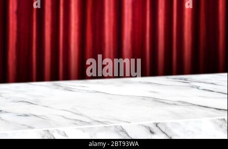 marble diagonal table with red red curtain wall blur background.Mock up  banner for display of product Stock Photo