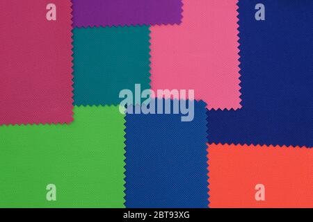 Samples of fabrics in different colors. Blue, green, pink piece of fabric with texture. Lightweight fabric made of synthetic fibres (nylon or polyeste Stock Photo