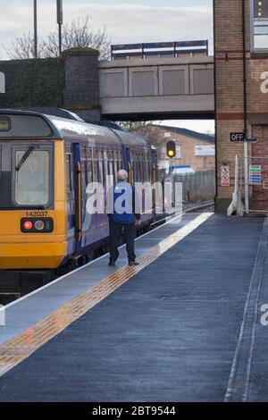 Guard conductor of a Northern rail class 142 pacer train waiting time at Kirkham and Wesham railway station before departure time Stock Photo