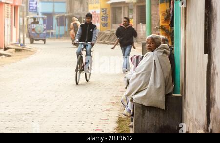 Murshidabad, West Bengal/India - January 16 2018: Street portrait of a woman who sits on a porch outside her house in the streets of Murshidabad. Stock Photo