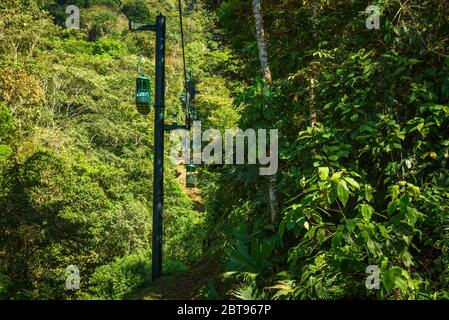 Cable car cabins riding through the tropical rainforest near Jaco in Costa Rica Stock Photo