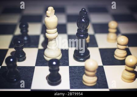 the chessboard with Black King and white King in front in the concept of agreement with arounds pawns. Stock Photo