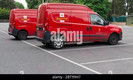 24 May 2020 - England, UK: Red Royal Mail vans side by side in car park Stock Photo