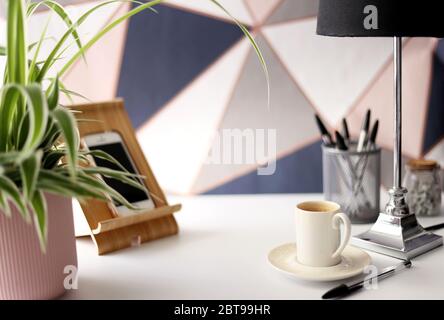Home office place with stationery, cup of coffee on multicolor background. Home office working station concept Stock Photo