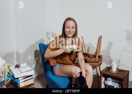 Environmental portrait of a female artist in her basement apartment in Prague Stock Photo