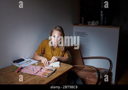 Environmental portrait of a female artist in her basement apartment in Prague Stock Photo