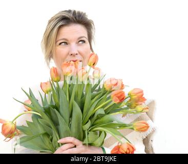 dutch flowers tulips beautiful woman behind flowers Stock Photo