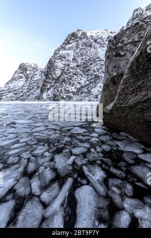 Winter landscape on a lake during Lofoten islands winter. Snow and ice melting Stock Photo