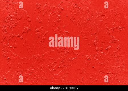 seamless texture of flat thick red maple color painted yellow surface under direct sunlight - new paint over fragments of old peeled one Stock Photo