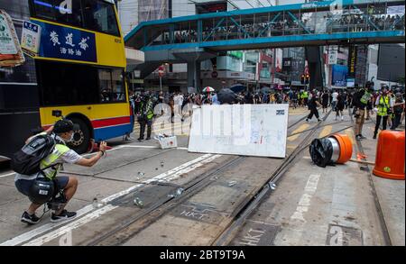 Hong Kong, China. 24th May, 2020. HONG KONG, HONG KONG SAR, CHINA: MAY 24th 2020. Twenty-three years after Hong Kong was handed by Britain back to Chinese rule, Beijing is pushing to implement tough new national security laws that will suppress the pro-democracy protests seen in the city. It is believed to be the end of the handover deal where China agreed to the one country, two systems idea. People take to the streets for an illegal protest in Causeway Bay shopping district Alamy Live news/Jayne Russell Credit: Jayne Russell/Alamy Live News Stock Photo