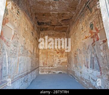 Hieroglypic carvings and paintings on interior room wall at the ancient egyptian temple of Medinat Habu in Luxor Stock Photo