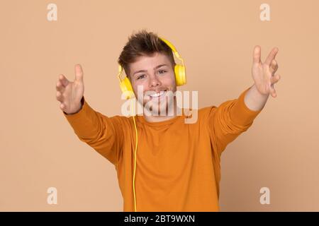 Attractive young guy on a yellow background Stock Photo