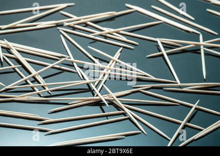 Natural White Birch Wooden Toothpicks on black mirror background Stock Photo