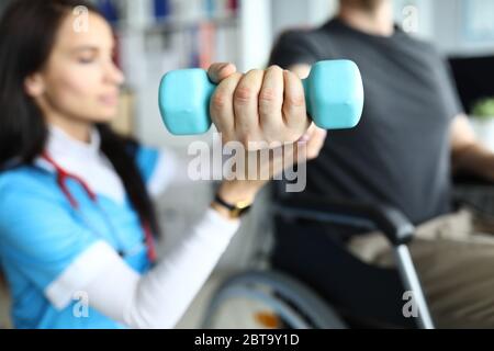 Man on stroller doing exercises with dumbbells Stock Photo