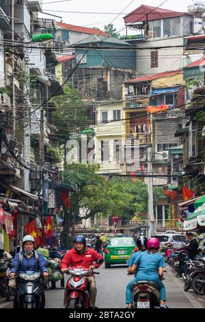 Hanoi, Vietnam, December 30, 2019, Tourists and bikers on a street of the old quarter Stock Photo