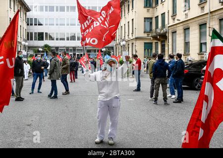Turin, Italy - 30 April, 2020: A medical worker waves a flag during a medical workers protest organized by CGIL and UIL trade unions against dysfunctions in the Piedmont region's handling of the COVID-19 coronavirus crisis. Credit: Nicolò Campo/Alamy Live News Stock Photo