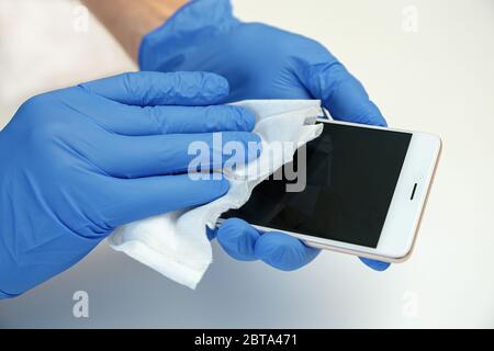 Smartphone Wipe Disinfectants. Covid-19 sanitizing office space wiping corona virus cleaning and disinfection of your workspace. Stock Photo