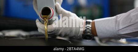 Timely replacement oil in car with new one oil. Stock Photo