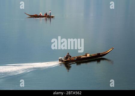 View of two 'Plätten', traditional wooden flat-bottomed boats, on Lake Hallstatt, Salzkammergut region, Austria Stock Photo