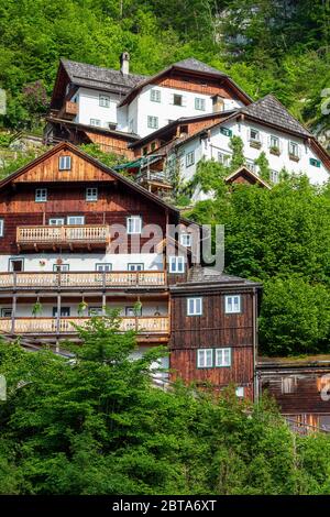 Traditional old house with partly wooden facade built into the rock high above the mountain village Hallstatt in the Salzkammergut region, OÖ, Austria Stock Photo