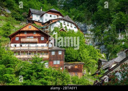 Traditional old house with partly wooden facade built into the rock high above the mountain village Hallstatt in the Salzkammergut region, OÖ, Austria Stock Photo