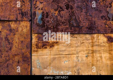 Rusted flat composite nailed metal sheets surface background and texture. Stock Photo