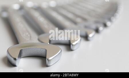 Spanners. Many wrenches. Grey background. Set of wrenches in different sizes on grey background.Close up. Blurred background. Stock Photo