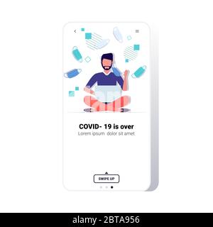 man taking off face mask guy sitting lotus pose using laptop victory over coronavirus pandemic quarantine covid-19 is ending concept smartphone screen mobile app copy space full length vector illustration Stock Vector