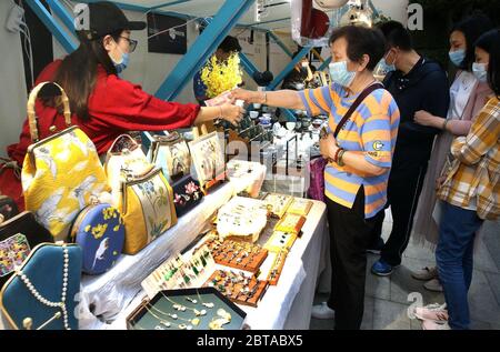 Shanghai, China. 24th May, 2020. Tourists shop at a night fair of Sinan Mansions in Shanghai, east China, May 24, 2020. A night fair of Sinan Mansions with food stalls, open air museum and art exhibitions etc., opened to boost Shanghai's nighttime economy. Credit: Chen Fei/Xinhua/Alamy Live News Stock Photo