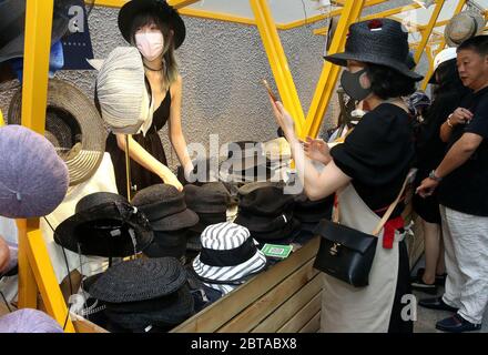 Shanghai, China. 24th May, 2020. Tourists shop at a night fair of Sinan Mansions in Shanghai, east China, May 24, 2020. A night fair of Sinan Mansions with food stalls, open air museum and art exhibitions etc., opened to boost Shanghai's nighttime economy. Credit: Chen Fei/Xinhua/Alamy Live News Stock Photo