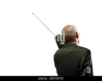 Senior business man using vintage radio Stock Photo