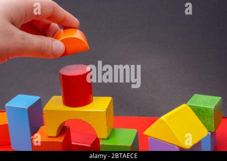 hand  building tower with colorful building blocks Stock Photo