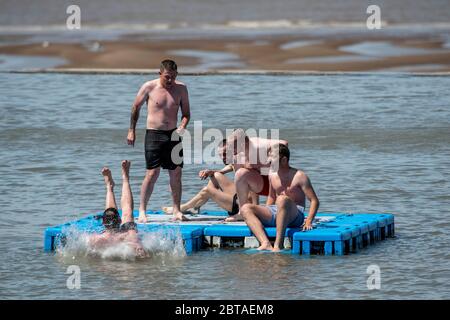 A group of young men enjoy the sunshine in Clevedon Marine Lake in Somerset after lockdown restrictions were eased in England last week. Stock Photo