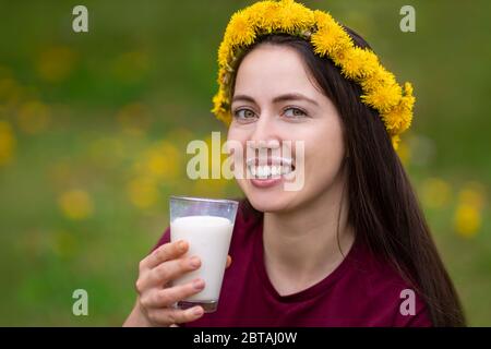 young woman drinking milk outdoors Stock Photo