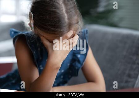 Upset little girl feel lonely sad at home Stock Photo