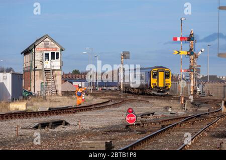 Northern Rail class 156 sprinter train arriving at Blackpool North railway station with the mechanical semaphore signals and number 2 signal box Stock Photo