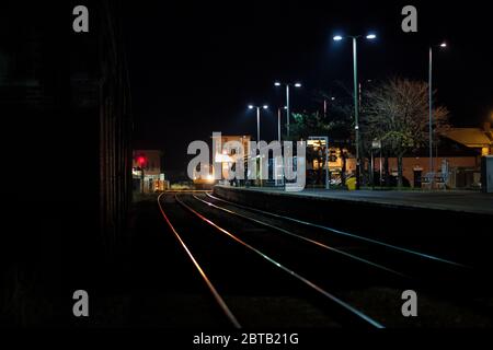 Northern rail class 142 pacer train arriving at a dark Redcar central station with the signal box Stock Photo