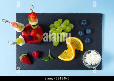 Fresh citruses on dark stone background. Oranges and limes. Top view with copy space Stock Photo