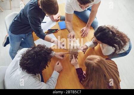 Top view game board.Young people have fun playing board games while sitting at a table in the room. Stock Photo