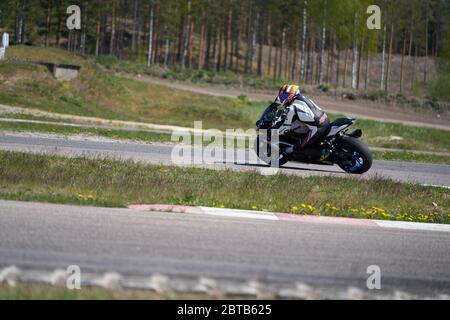 10-05-2020 Ropazi, Latvia Motorcycle practice leaning into a fast corner on track. Stock Photo