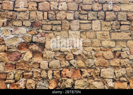 Ancient brickwork destroyed by time closeup as background Stock Photo