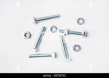 Steel bolts and nuts in bulk isolated on white Stock Photo