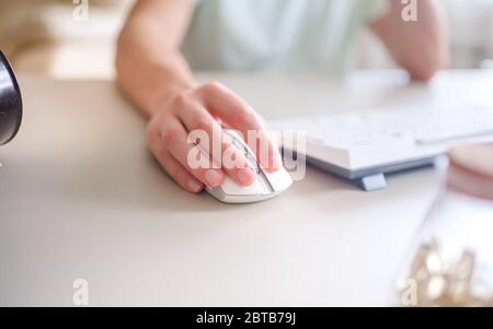 the developer works at computer, uses the mouse Stock Photo