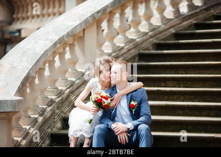 Fabulous young wedding couple posing in the park on the sunny day. Stock Photo
