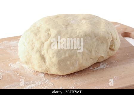 Slice of dough in flour on a wooden cutting board Stock Photo
