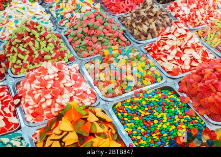 Different multi-colored sweets on a counter in a market close-up Stock Photo