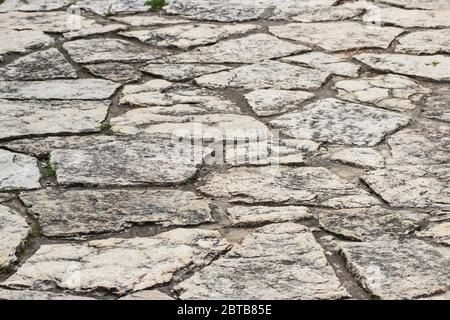 The path in the park is laid with natural stone Stock Photo